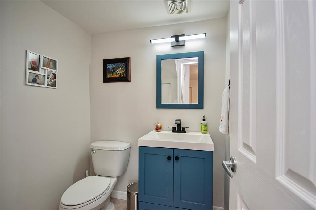 9500 Southwest 3rd Street, Unit 248 Boca Raton, FL 33428 - Photo 18 of 47 a bathroom with a toilet sink and mirror