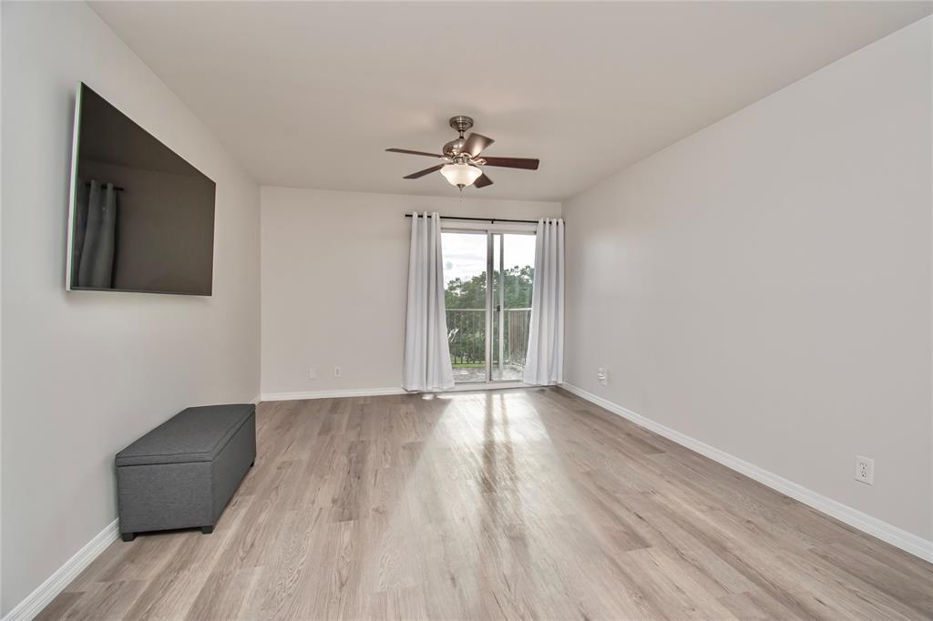9500 Southwest 3rd Street, Unit 248 Boca Raton, FL 33428 - Photo 20 of 47 a view of an empty room with wooden floor and a window