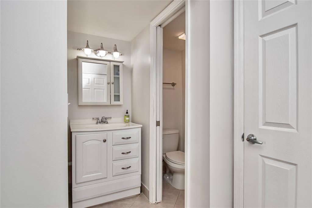 9500 Southwest 3rd Street, Unit 248 Boca Raton, FL 33428 - Photo 25 of 47 a bathroom with a toilet a sink and mirror