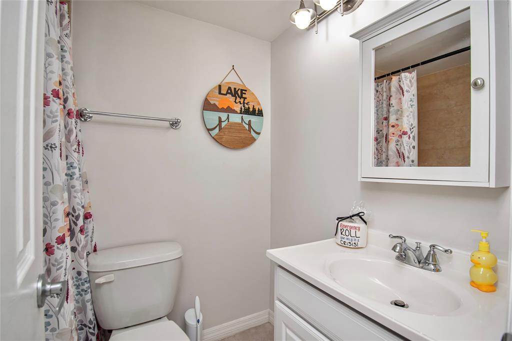 9500 Southwest 3rd Street, Unit 248 Boca Raton, FL 33428 - Photo 29 of 47 a bathroom with a toilet sink and mirror