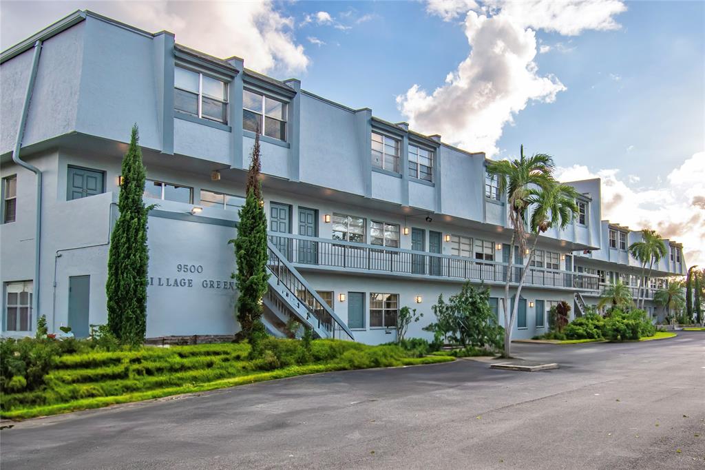 9500 Southwest 3rd Street, Unit 248 Boca Raton, FL 33428 - Photo 33 of 47 a front view of a residential apartment building with a yard