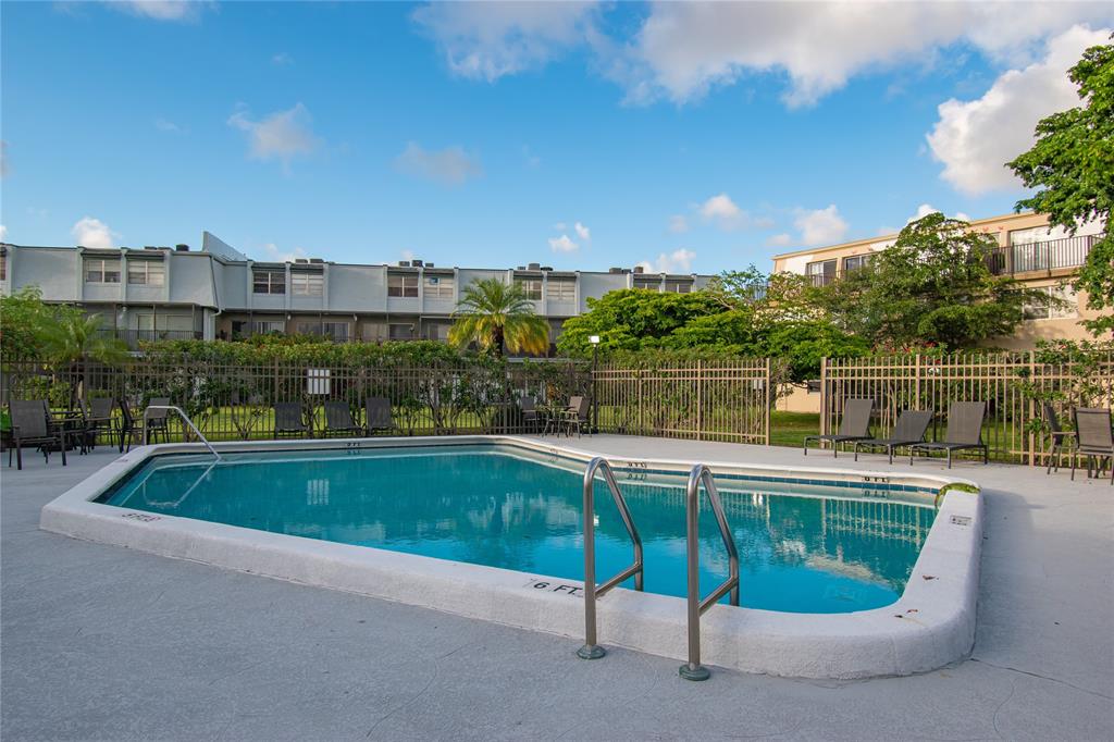 9500 Southwest 3rd Street, Unit 248 Boca Raton, FL 33428 - Photo 34 of 47 a view of a swimming pool with a terrace and seating space