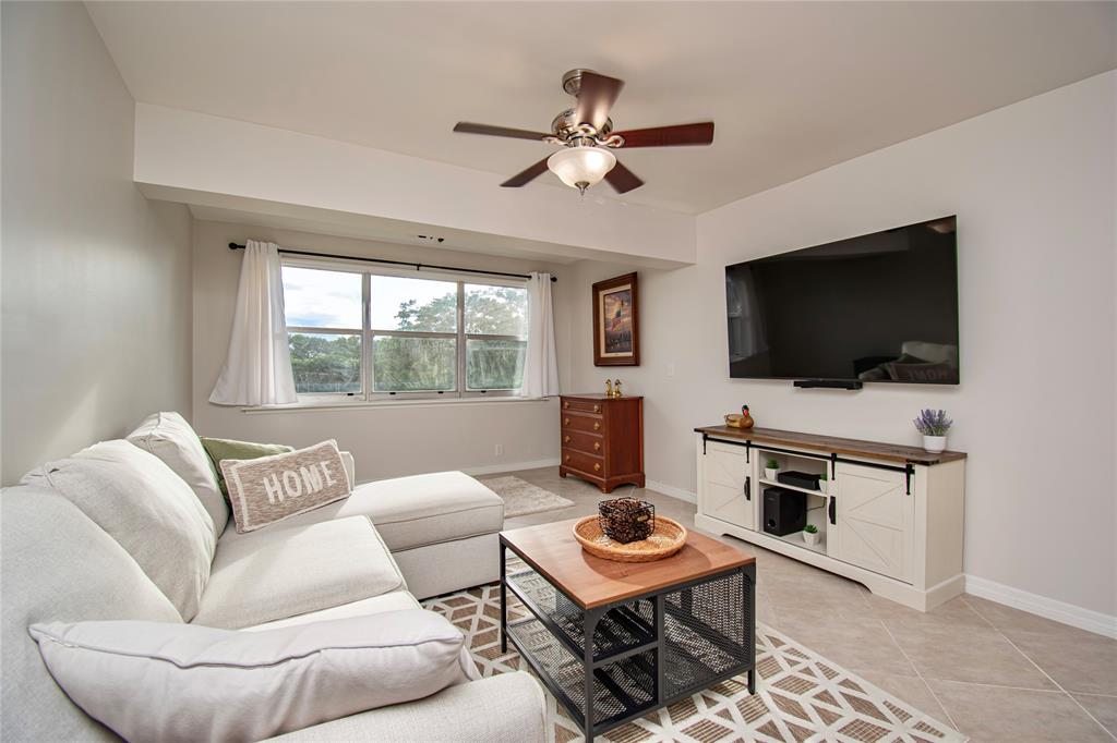 9500 Southwest 3rd Street, Unit 248 Boca Raton, FL 33428 - Photo 4 of 47 a living room with furniture and a flat screen tv