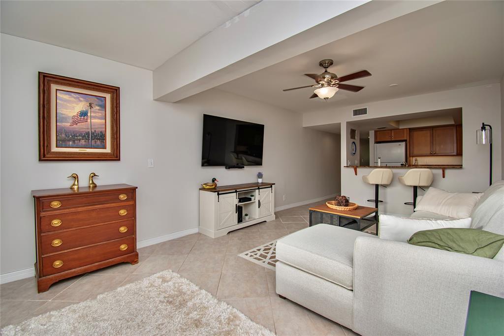 9500 Southwest 3rd Street, Unit 248 Boca Raton, FL 33428 - Photo 9 of 47 a living room with furniture and a flat screen tv
