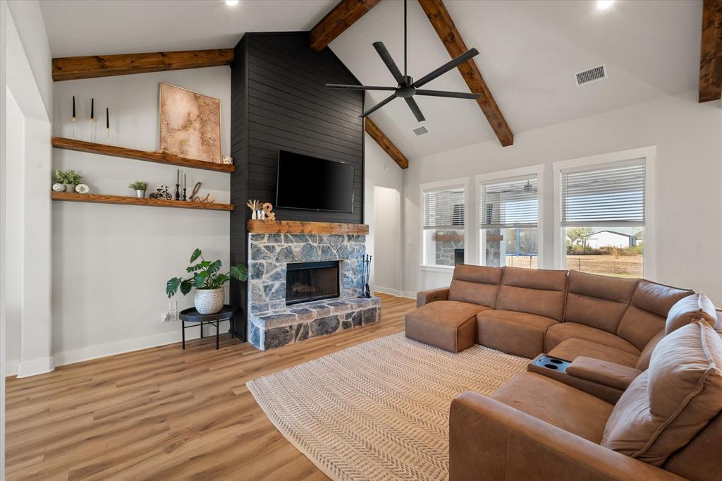 8221 David Lane Midlothian, TX 76065 - Photo 11 of 34 a living room with furniture a flat screen tv and a fireplace