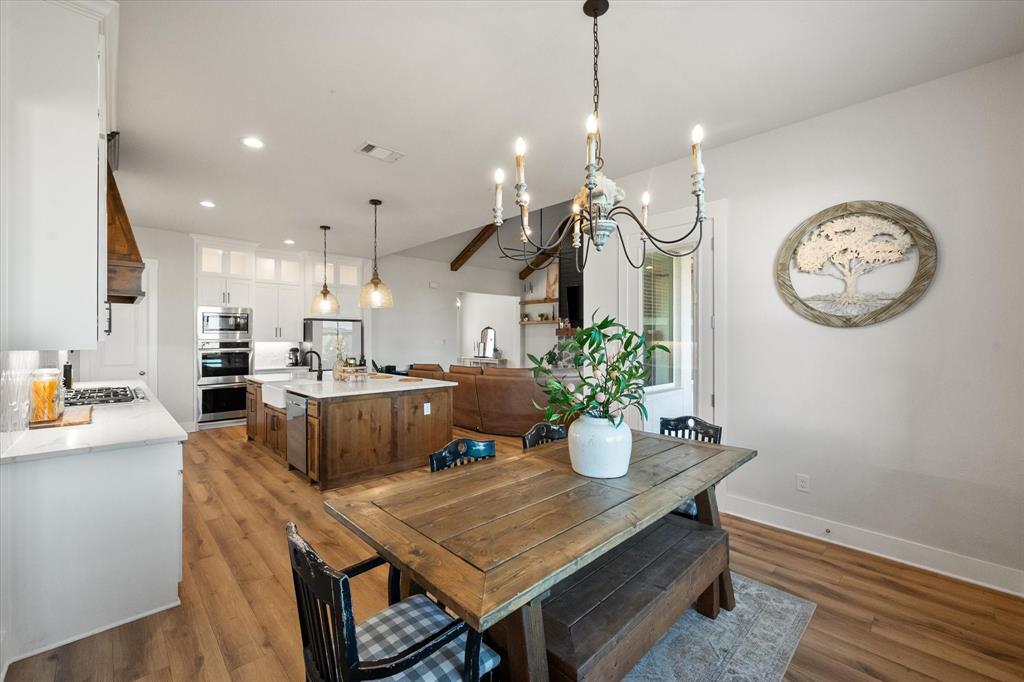 8221 David Lane Midlothian, TX 76065 - Photo 17 of 34 a kitchen with a table and chairs