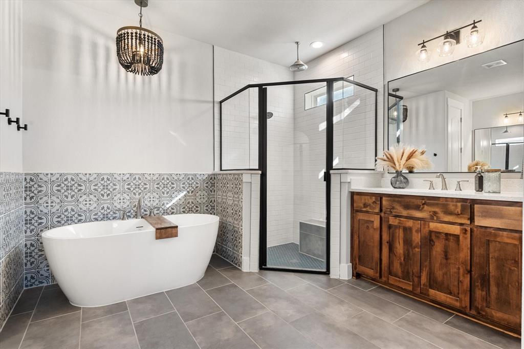 8221 David Lane Midlothian, TX 76065 - Photo 20 of 34 Bathroom with a soaking tub, tile walls, vanity, tile patterned floors, and a stall shower