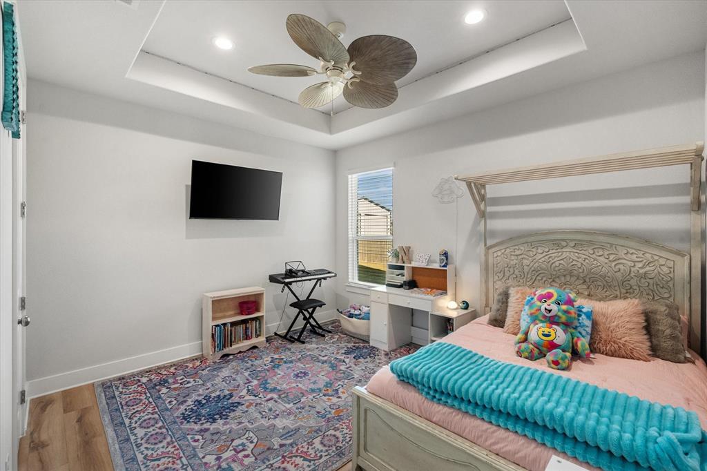 8221 David Lane Midlothian, TX 76065 - Photo 21 of 34 Bedroom featuring a tray ceiling, wood finished floors, ceiling fan, and recessed lighting