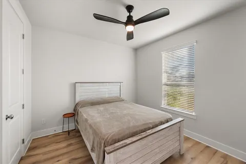 a bedroom with a bed and wooden floor