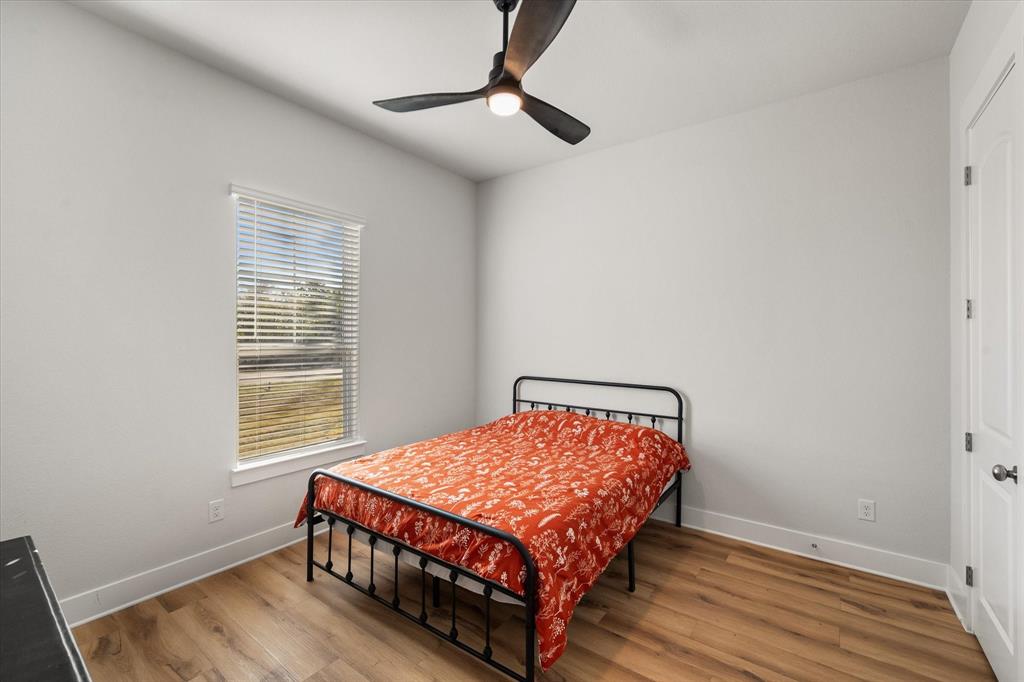 8221 David Lane Midlothian, TX 76065 - Photo 22 of 34 a bedroom with a bed and wooden floor