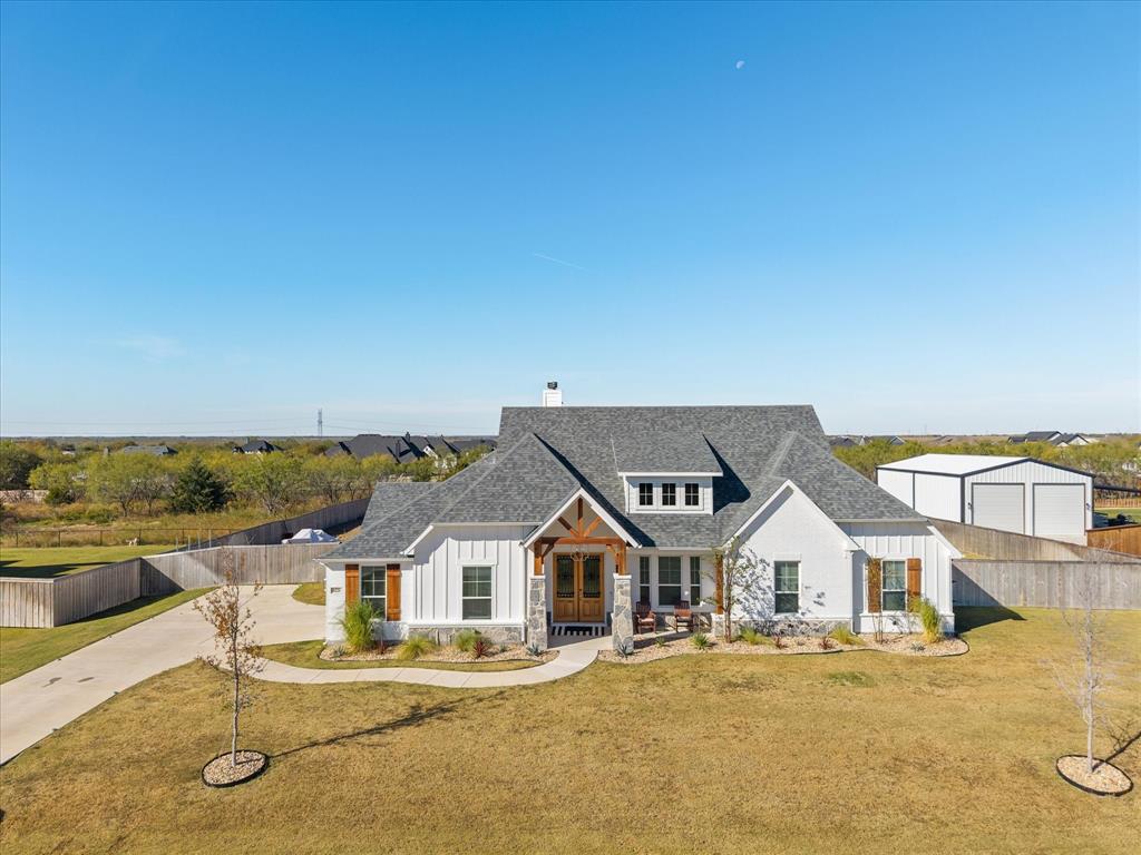 8221 David Lane Midlothian, TX 76065 - Photo 28 of 34 Modern farmhouse style home with stone siding, board and batten siding, a chimney, and a shingled roof
