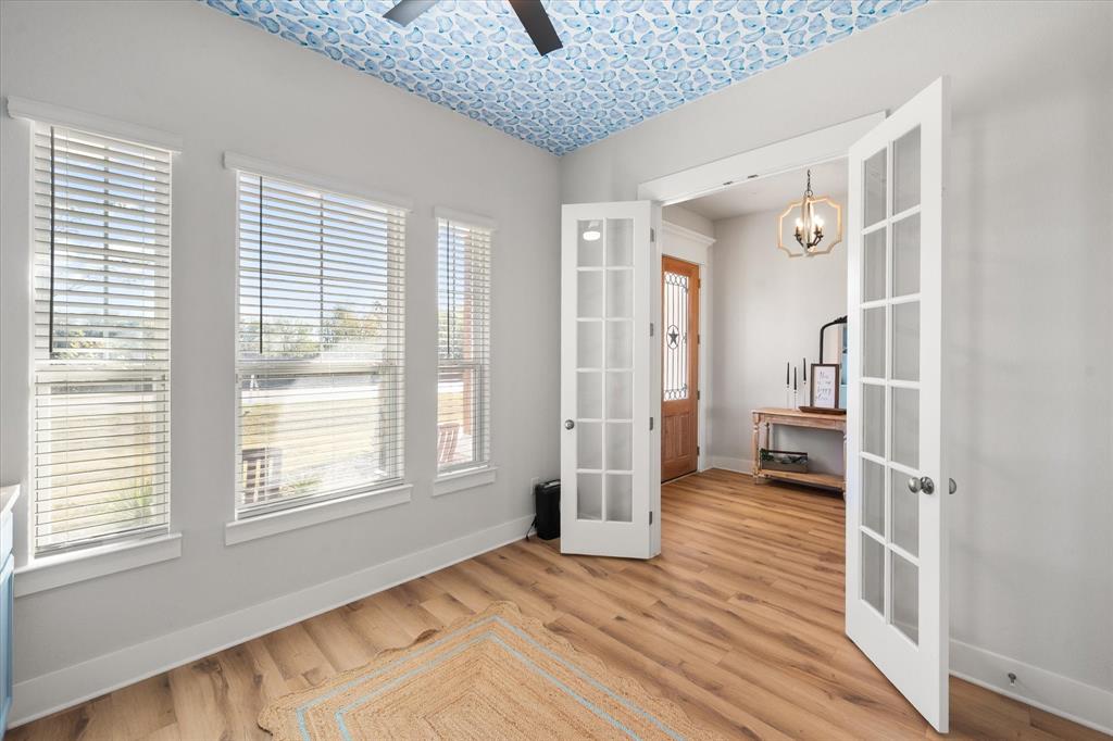 8221 David Lane Midlothian, TX 76065 - Photo 6 of 34 Spare room featuring french doors, light wood finished floors, and a fan