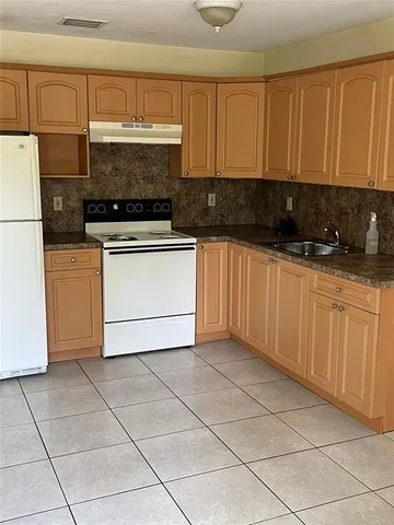 a kitchen with cabinets and appliances