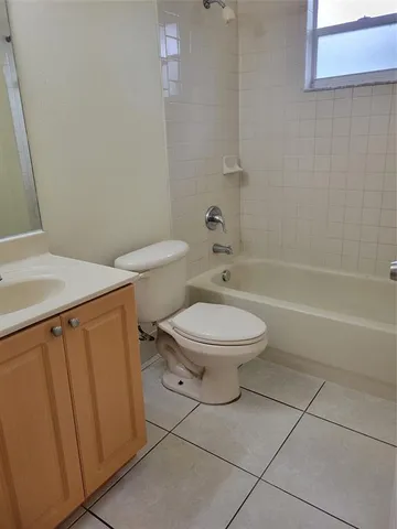 a white toilet sitting next to a bathroom sink and a shower