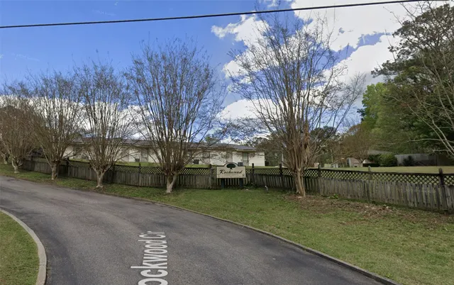a view of a backyard with wooden fence