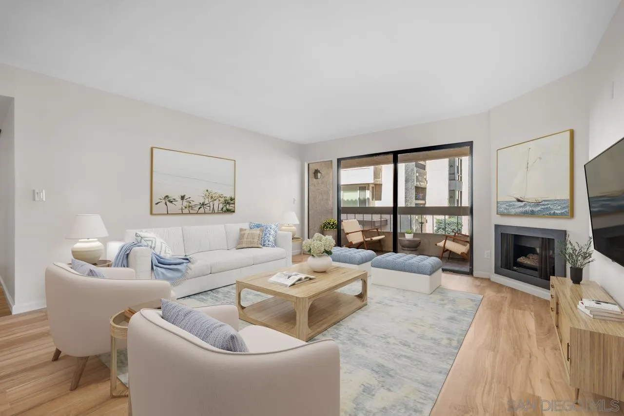 a living room with furniture large window and a fireplace