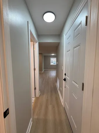 a view of hallway with wooden floor