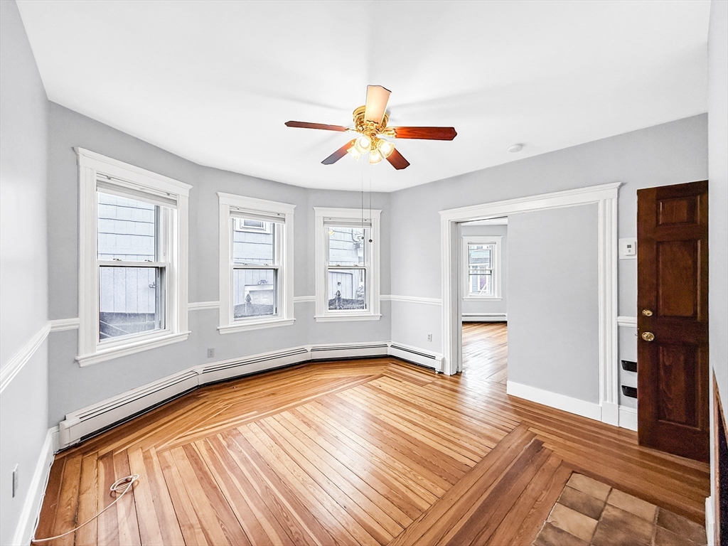 19 Moore Street Winthrop, MA 02152 - Photo 11 of 42 a view of empty room with wooden floor and fan