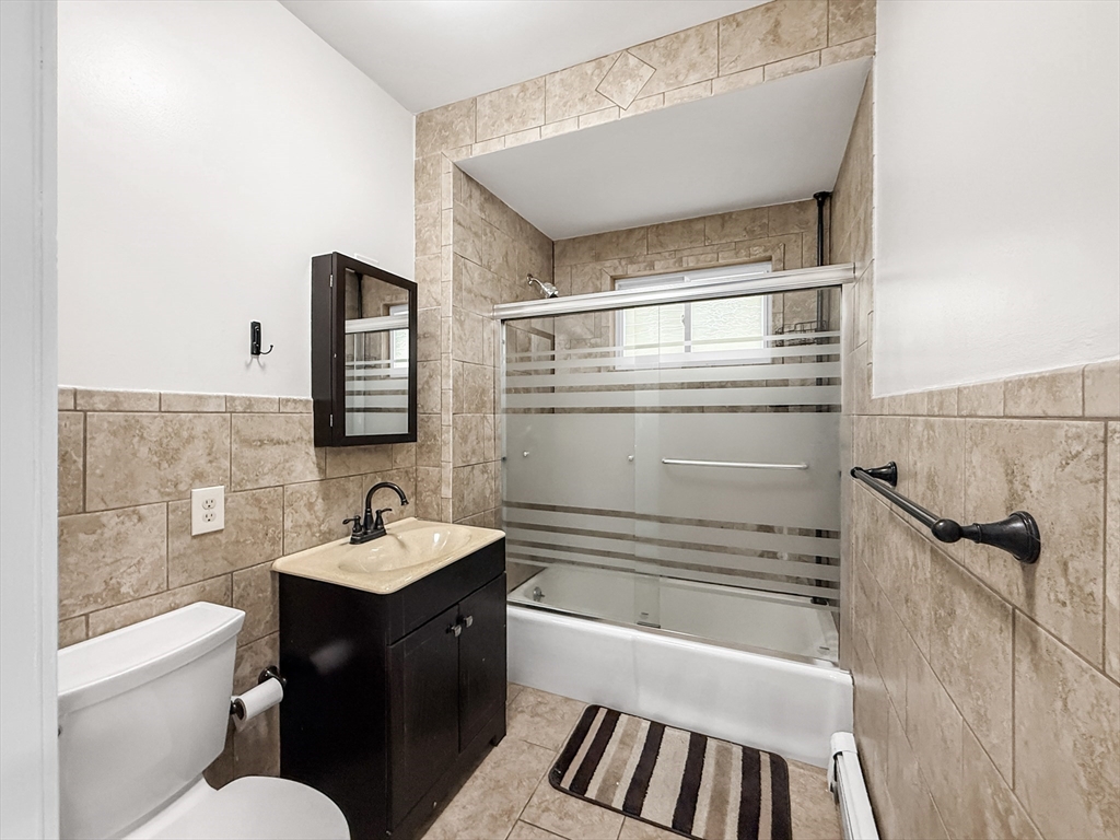 19 Moore Street Winthrop, MA 02152 - Photo 15 of 42 a bathroom with a sink a toilet and shower