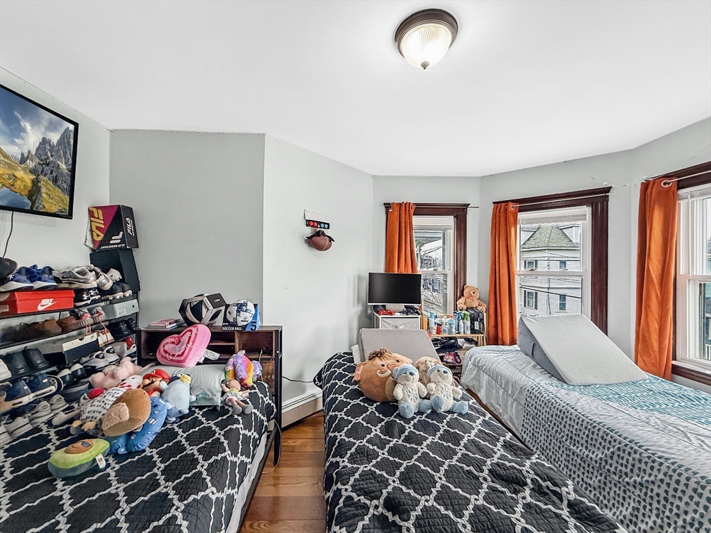 19 Moore Street Winthrop, MA 02152 - Photo 34 of 42 a bedroom with furniture toys and a large window