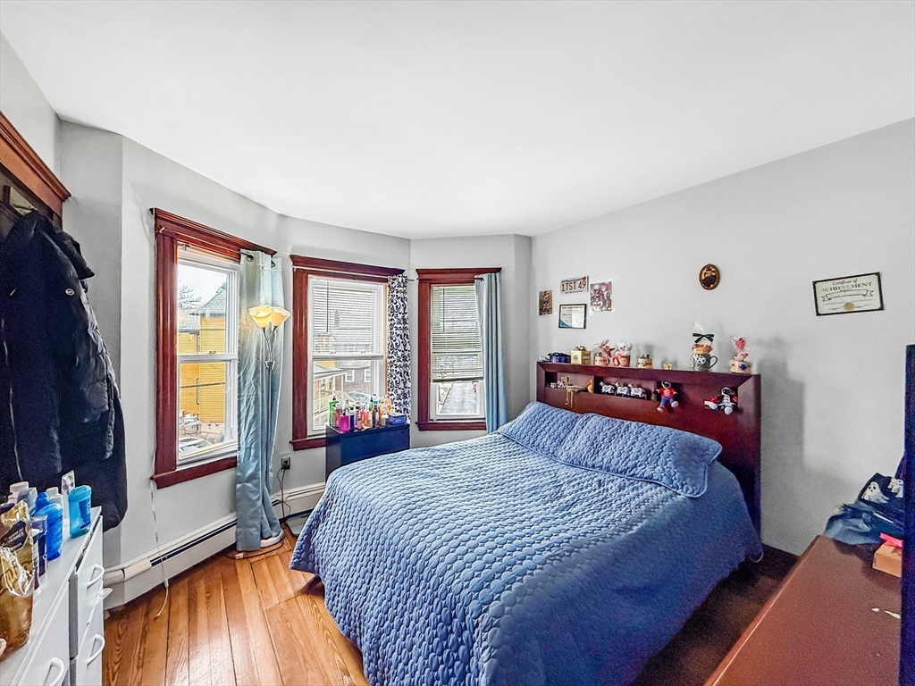 19 Moore Street Winthrop, MA 02152 - Photo 35 of 42 a bed sitting in a bedroom next to a window