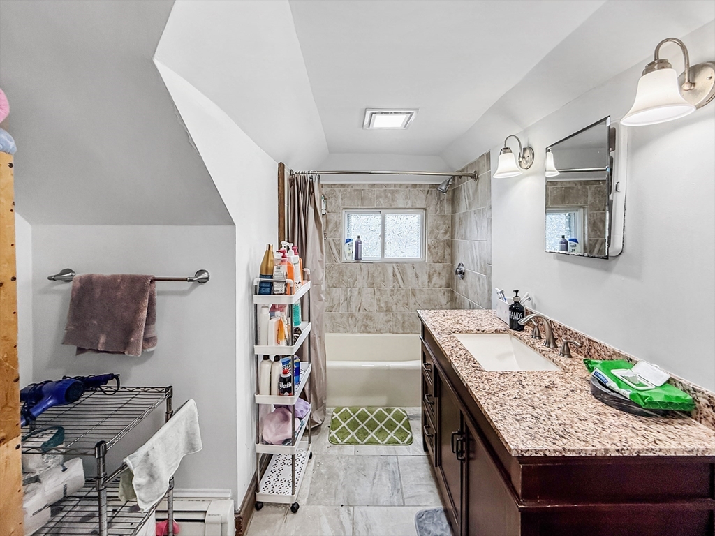 19 Moore Street Winthrop, MA 02152 - Photo 41 of 42 a bathroom with a granite countertop sink a mirror and shower
