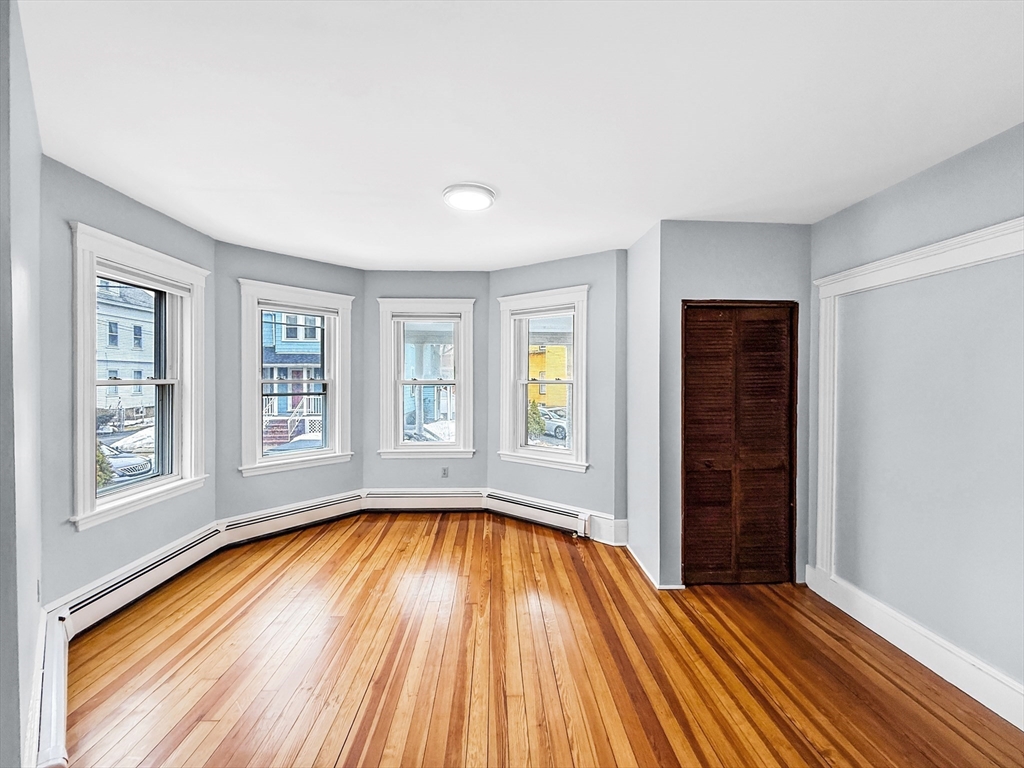 19 Moore Street Winthrop, MA 02152 - Photo 7 of 42 a view of an empty room with wooden floor and a window