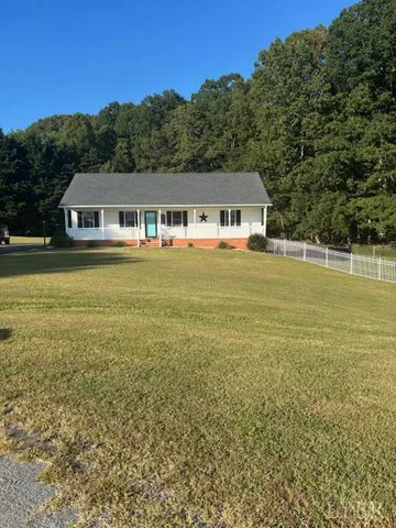 a front view of a house with a big yard