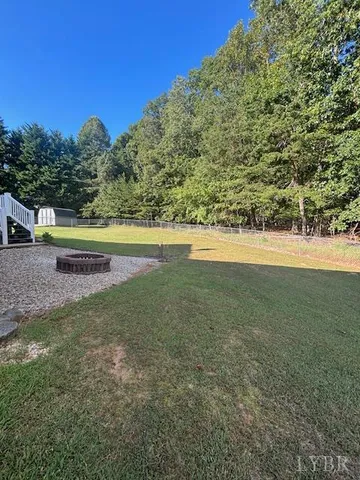 a view of a green yard with an outdoor space