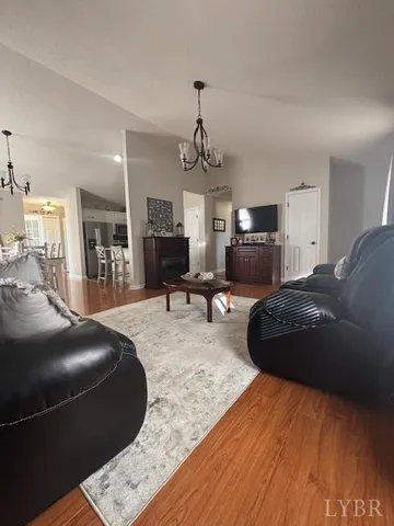 a bedroom with a bed chandelier and a view