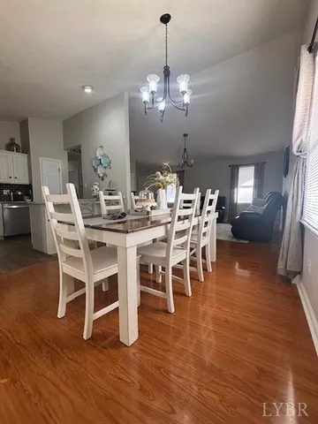 a view of a dining room with furniture wooden floor and chandelier