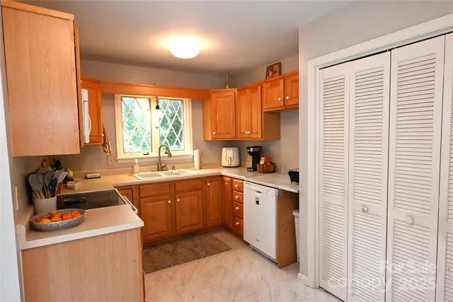 a kitchen with stainless steel appliances granite countertop a sink and a stove