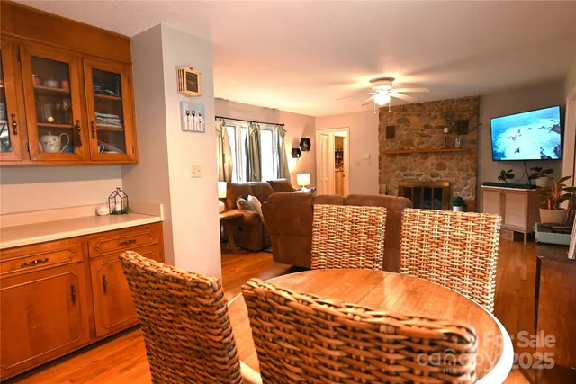 a living room with furniture a flat screen tv and floor to ceiling window