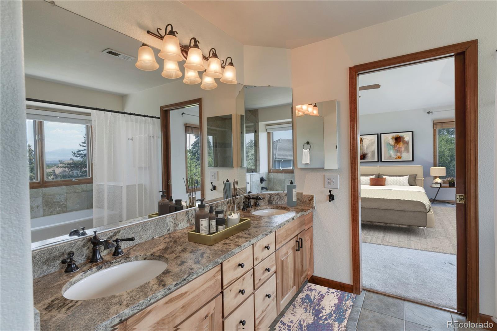 3756 West 100th Avenue Westminster, CO 80031 - Photo 11 of 45 a spacious bathroom with a granite countertop sink a light fixture and a mirror