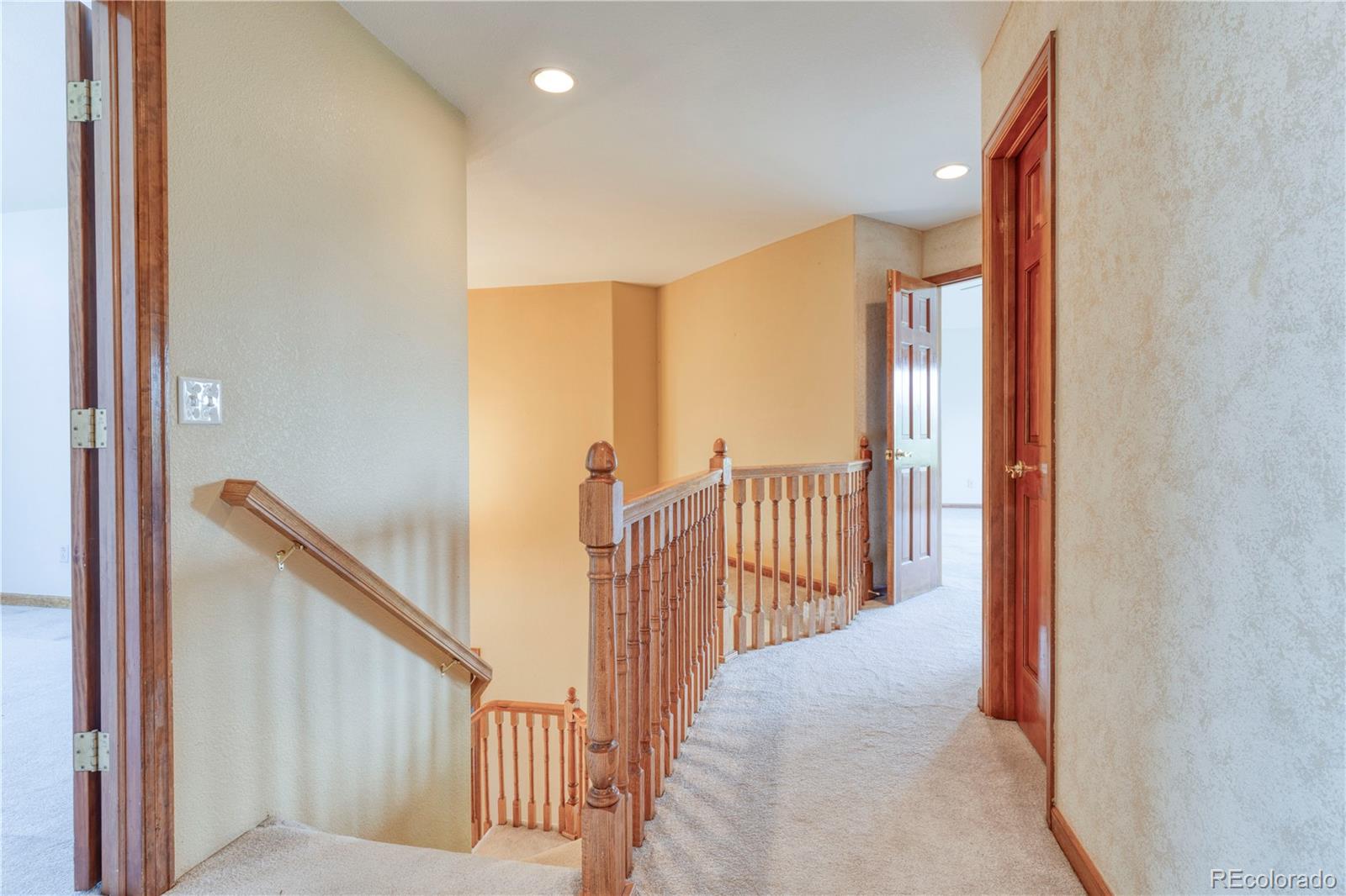 3756 West 100th Avenue Westminster, CO 80031 - Photo 23 of 45 a view of a hallway with wooden floor and stairs