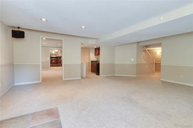 an empty room with closet and mirrors