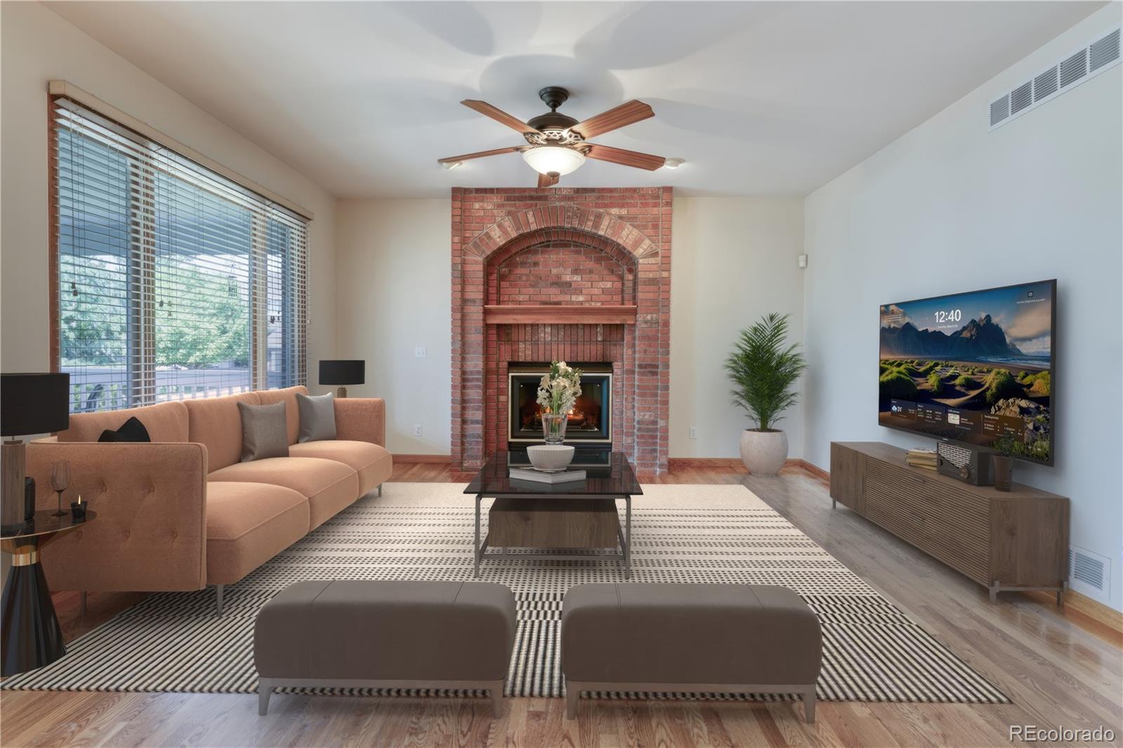 3756 West 100th Avenue Westminster, CO 80031 - Photo 3 of 45 a living room with furniture a fireplace and a large window