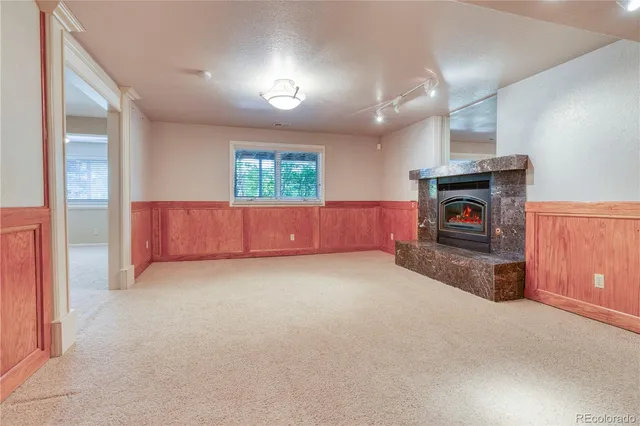an empty room with furniture and fireplace