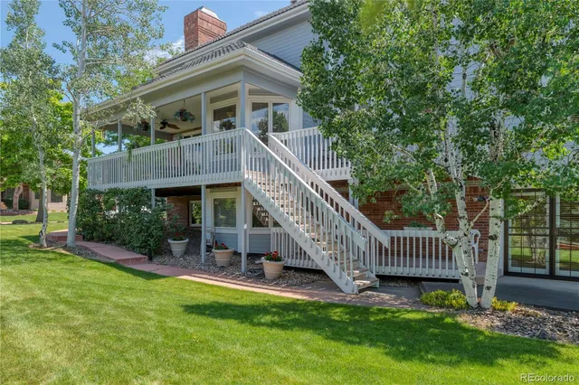 a view of a house with a yard and deck