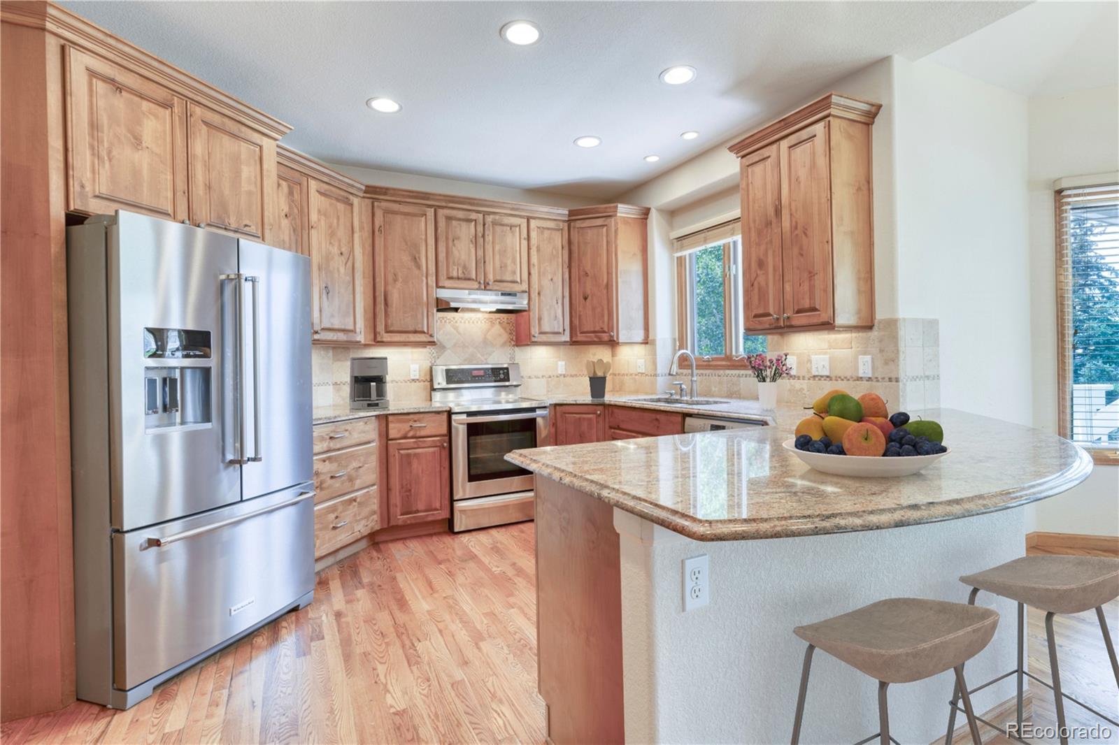 3756 West 100th Avenue Westminster, CO 80031 - Photo 4 of 45 a kitchen with refrigerator cabinets and wooden floor