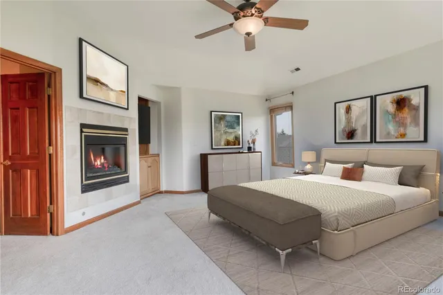 a spacious bedroom with a bed and a fireplace
