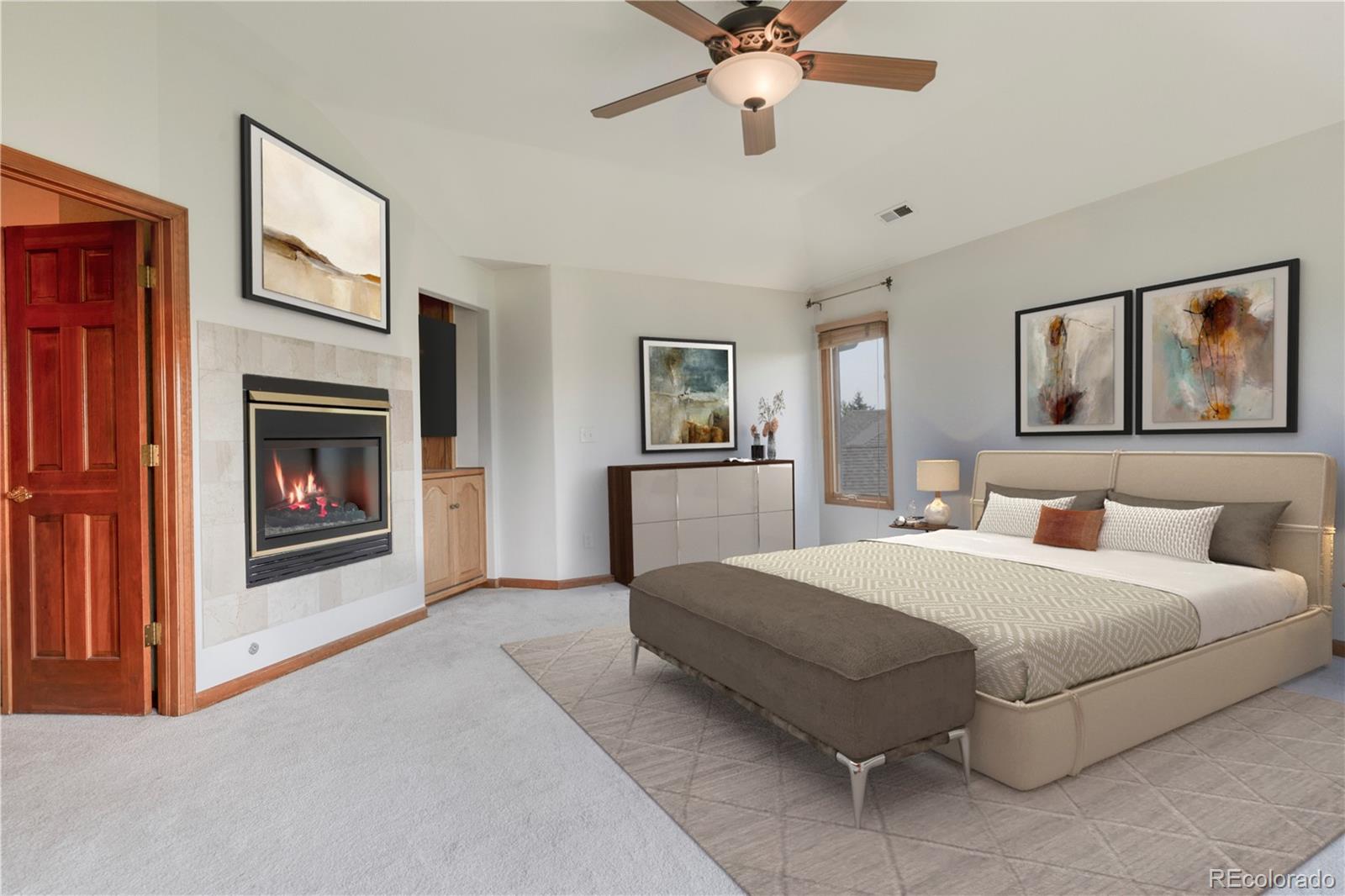 3756 West 100th Avenue Westminster, CO 80031 - Photo 10 of 45 a spacious bedroom with a bed and a fireplace