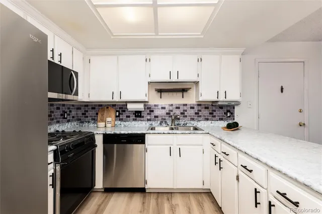 a kitchen with stainless steel appliances granite countertop a sink and cabinets
