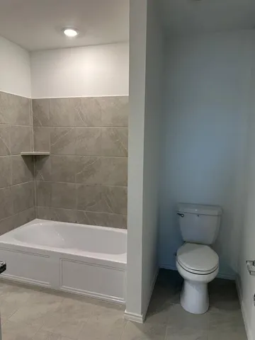 a bathroom with a toilet and a bathtub