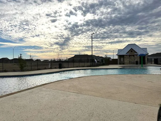 a view of swimming pool with lawn chairs