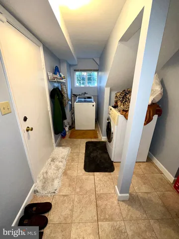 a bedroom with a large window and a rug