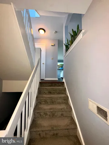 a kitchen with granite countertop a refrigerator stove top oven and sink