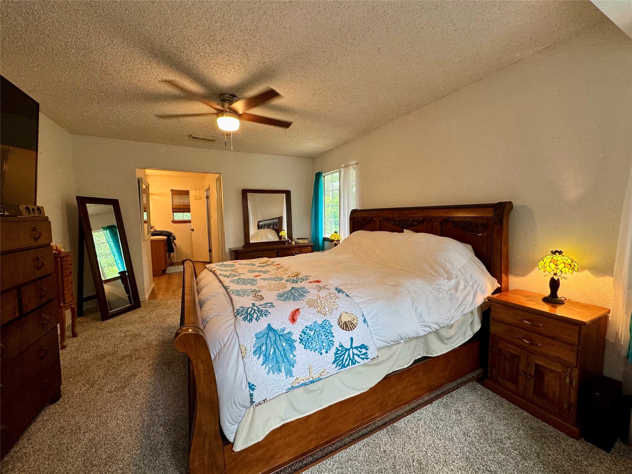 954 Hillbilly Heaven Road Livingston, TX 77351 - Photo 25 of 37 a bedroom with a bed and a chandelier