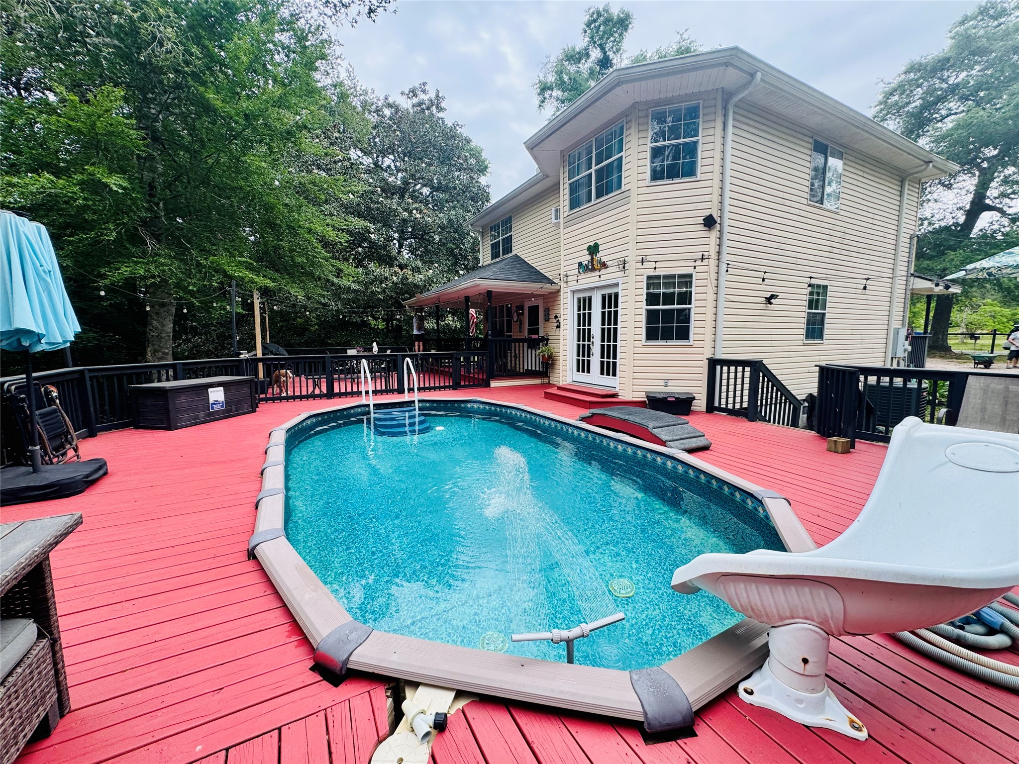 954 Hillbilly Heaven Road Livingston, TX 77351 - Photo 3 of 38 Beautiful backyard oasis with expansive deck. Split access with gate to ensure family safety around pool!