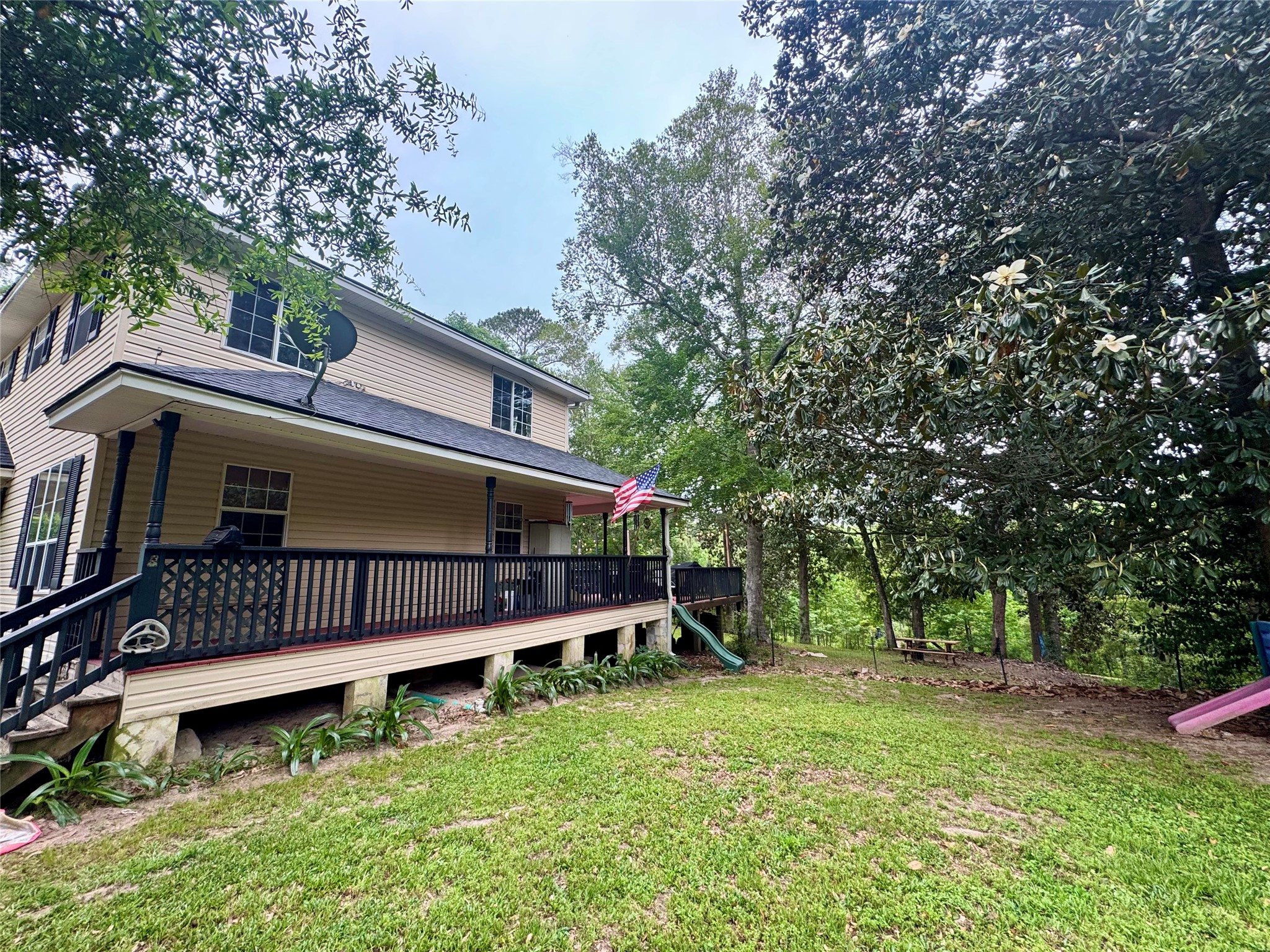 954 Hillbilly Heaven Road Livingston, TX 77351 - Photo 5 of 37 View of long side porch from fenced yard.